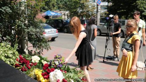 Жители Киева несут цветы к посольству Франции